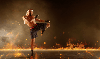 Blog post photos for muay thai medals, photo of a muay thai fighter wiith a fire background